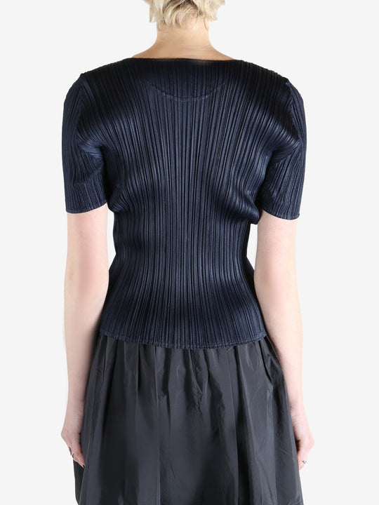 Navy top worn by a person, showing the top's fit