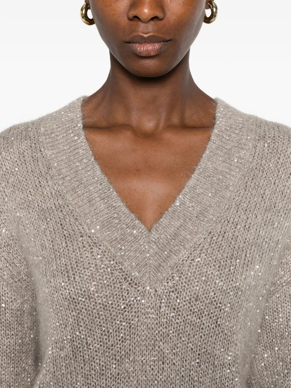 Tan hoodie worn by a person, showing the hoodie fit