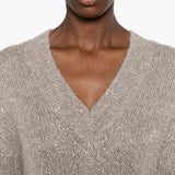 Tan hoodie worn by a person, showing the hoodie fit