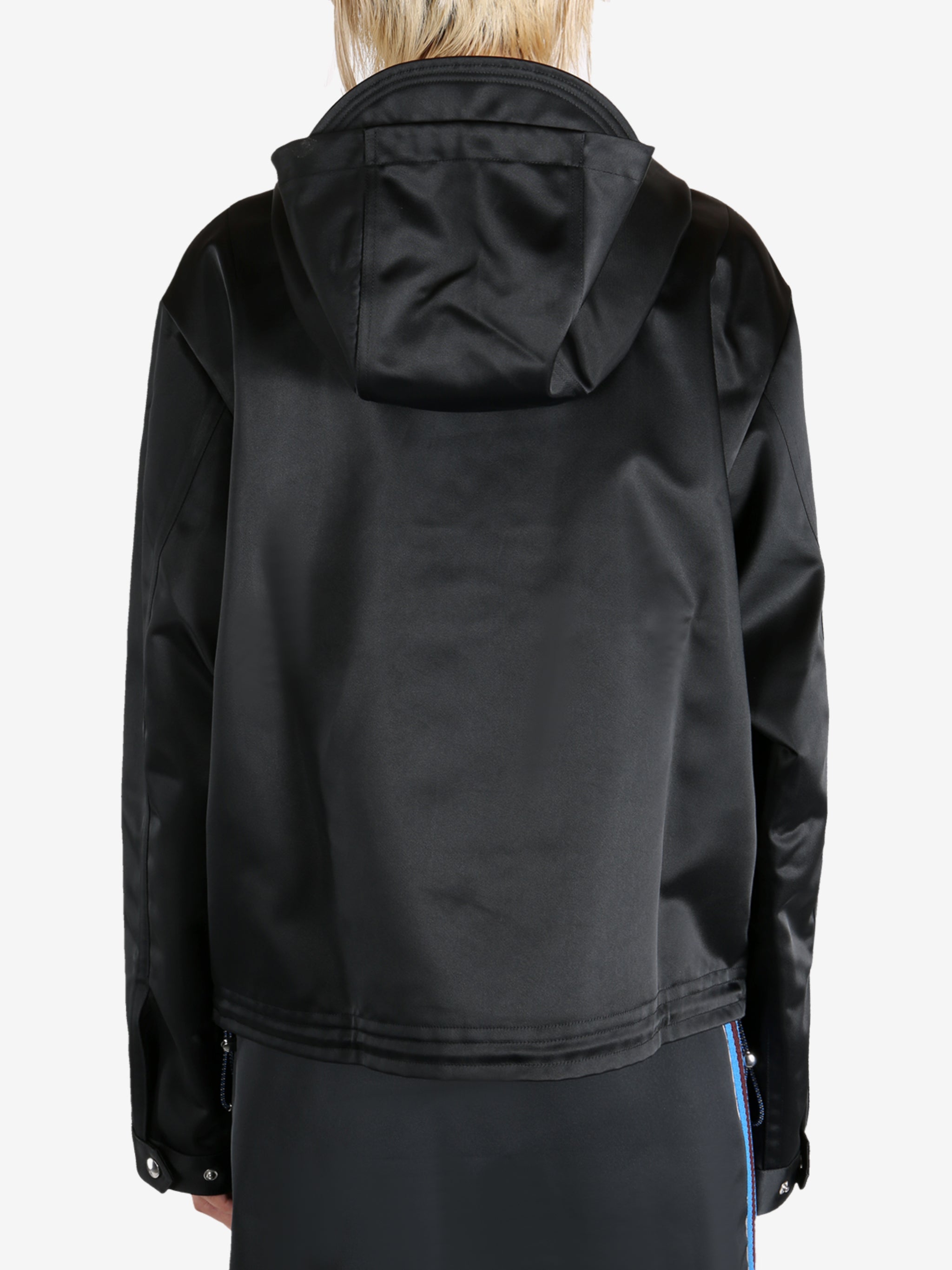 Black jacket worn by a person, showing the jacket's fit