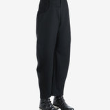 Black pants worn by a person, showing the pants' fit