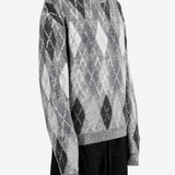 Grey knitwear worn by a person, showing the knitwear fit