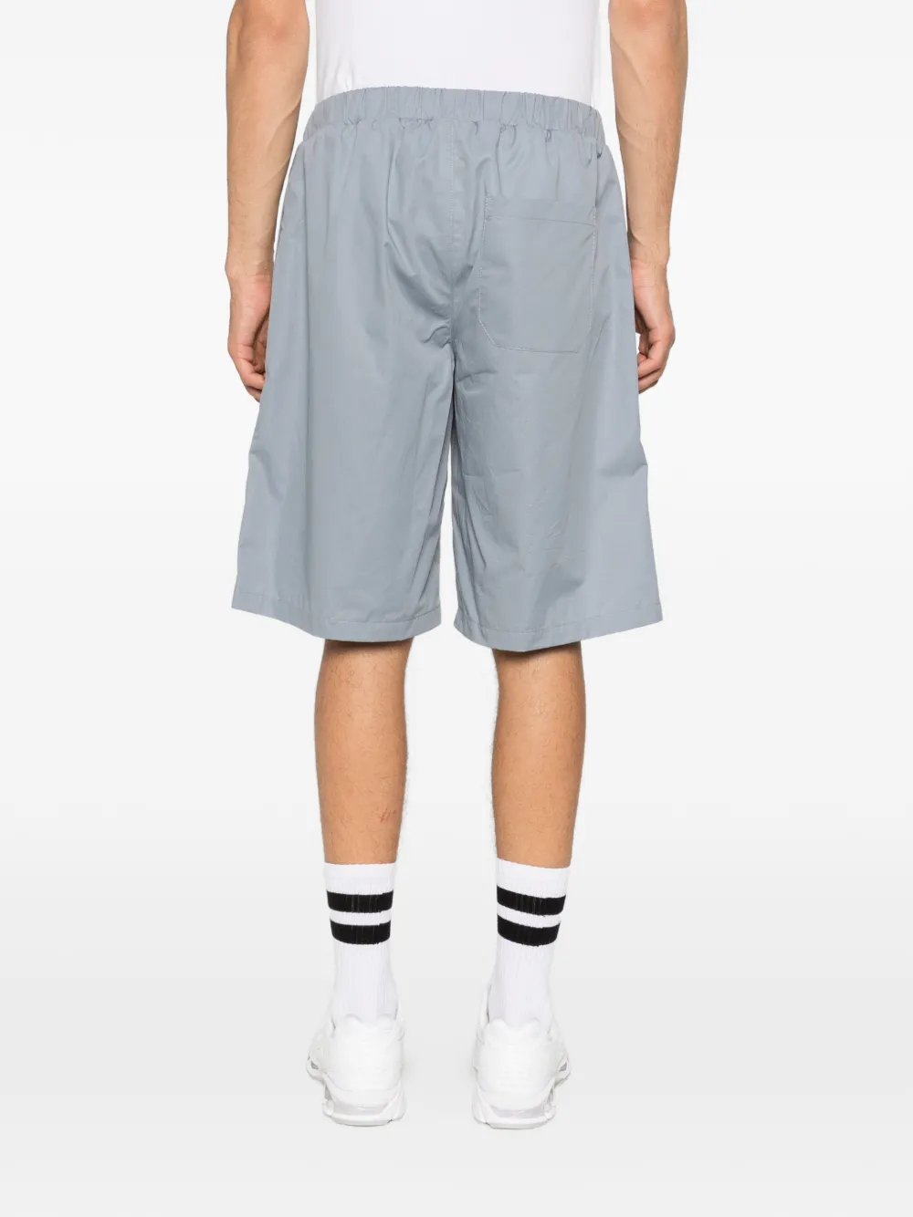 Grey shorts worn by a person, showing the shorts fit