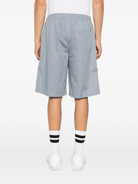 Grey shorts worn by a person, showing the shorts fit