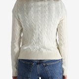 White pullover worn by a person, showing the pullover's fit