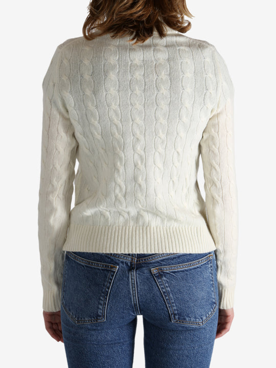 White pullover worn by a person, showing the pullover's fit