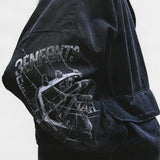 Close up of the black jacket, showing texture of the cotton fabric