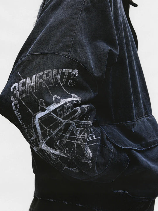 Close up of the black jacket, showing texture of the cotton fabric