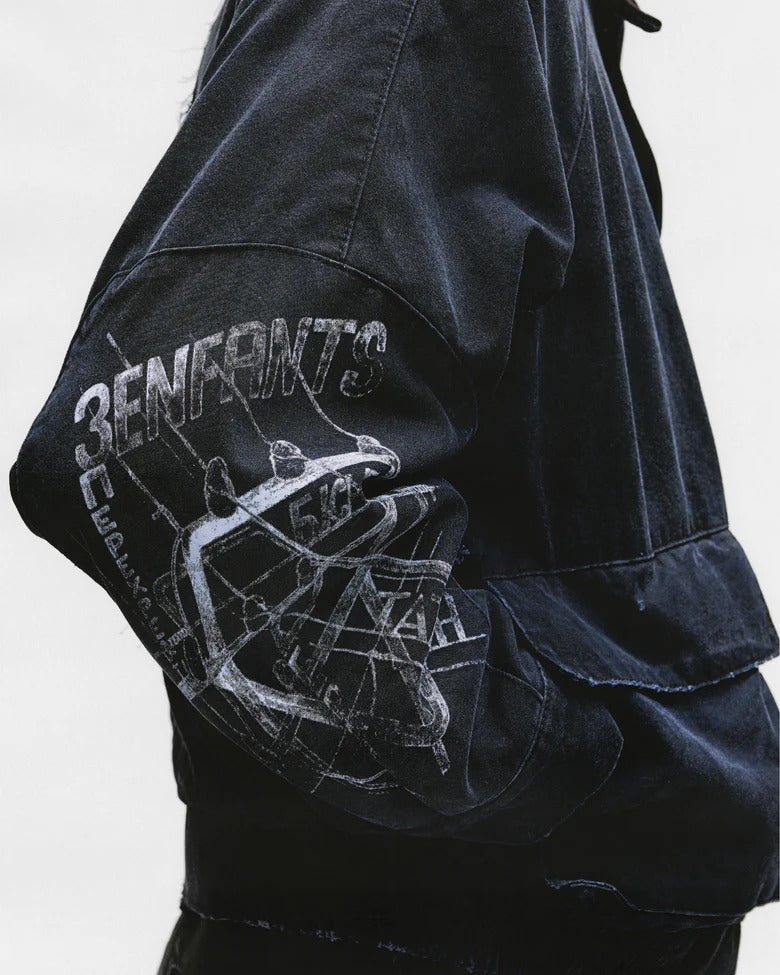 Close up of the black jacket, showing texture of the cotton fabric