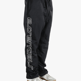 Black pants worn by a person, showing the pants's fit