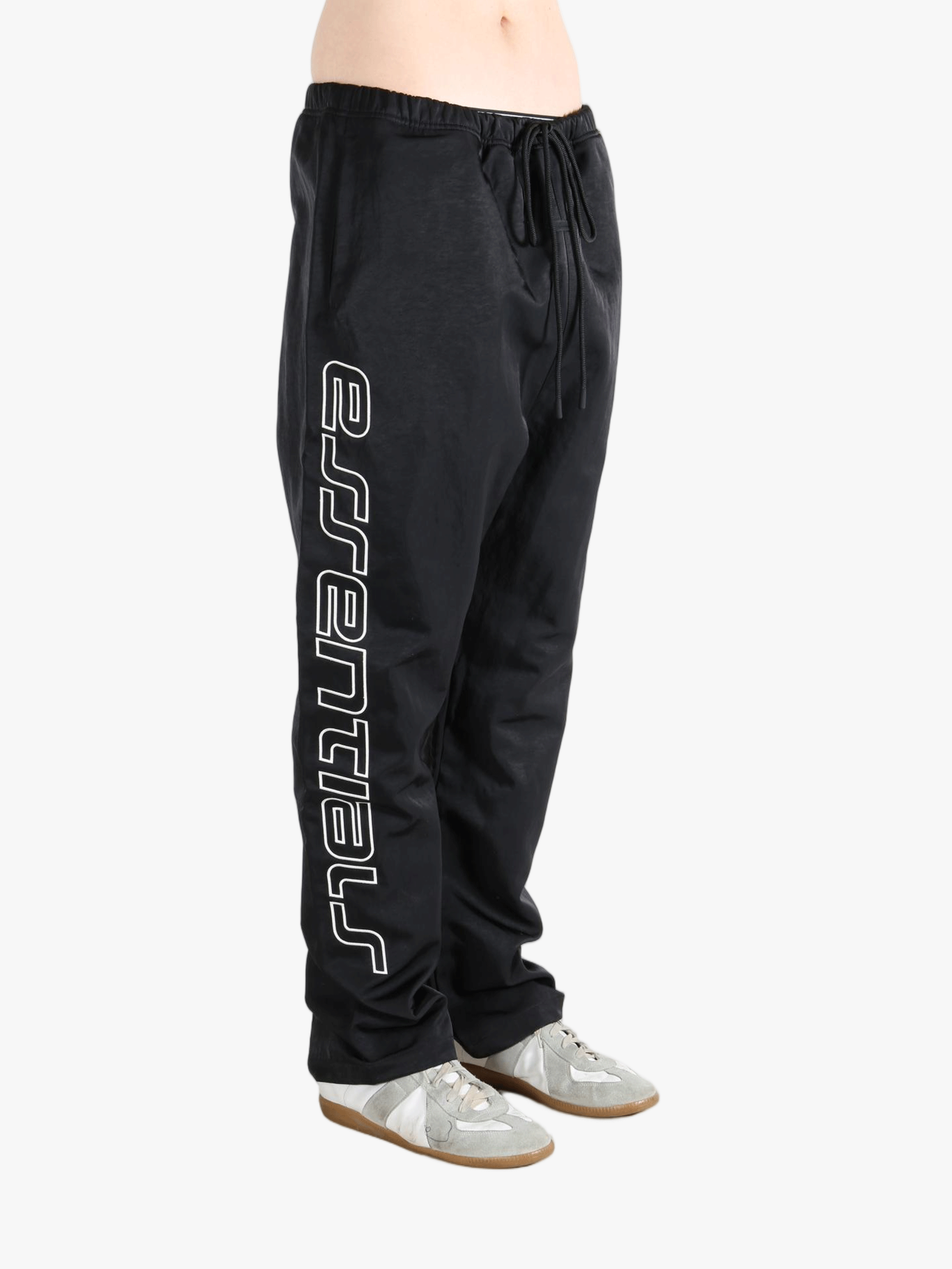 Black pants worn by a person, showing the pants's fit