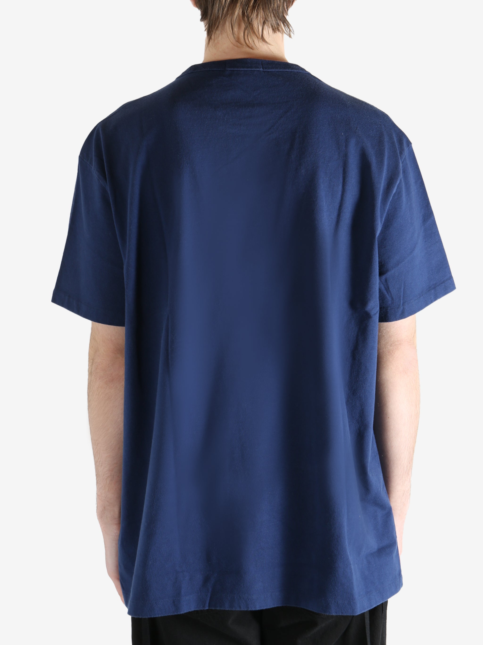Navy blue t-shirt worn by a person, showing the shirt's fit