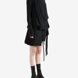 Black top worn by a person, showing the top's fit