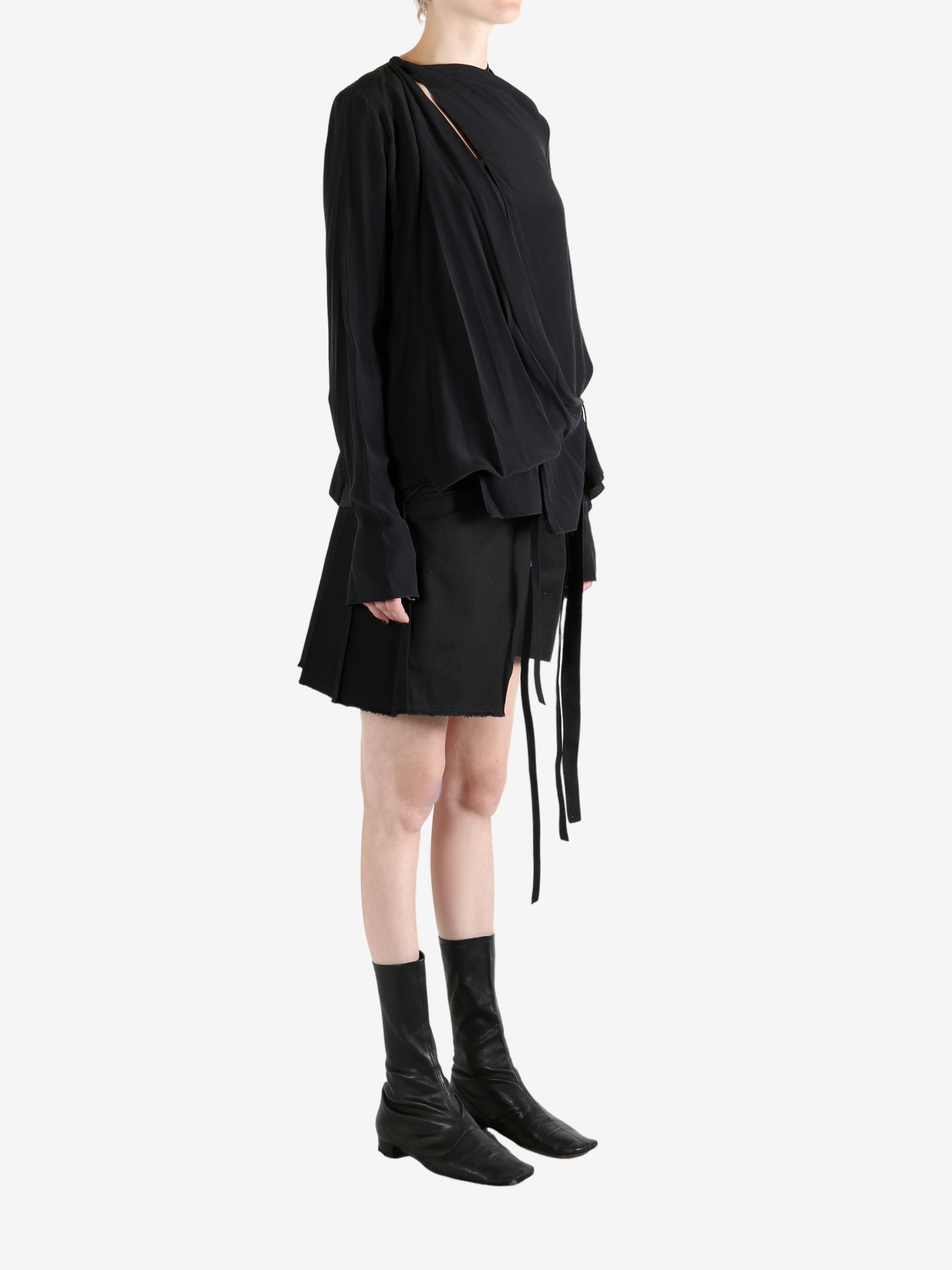 Black top worn by a person, showing the top's fit