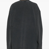 Black sweater worn by a person, showing the sweater fit