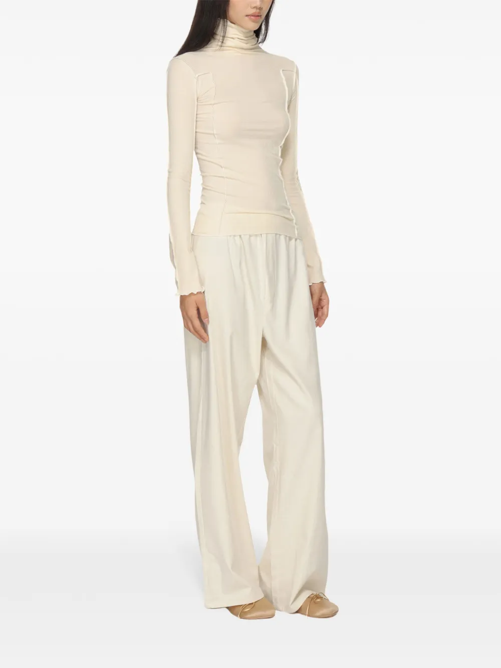 White top worn by a person, showing the top's fit