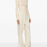 White top worn by a person, showing the top's fit