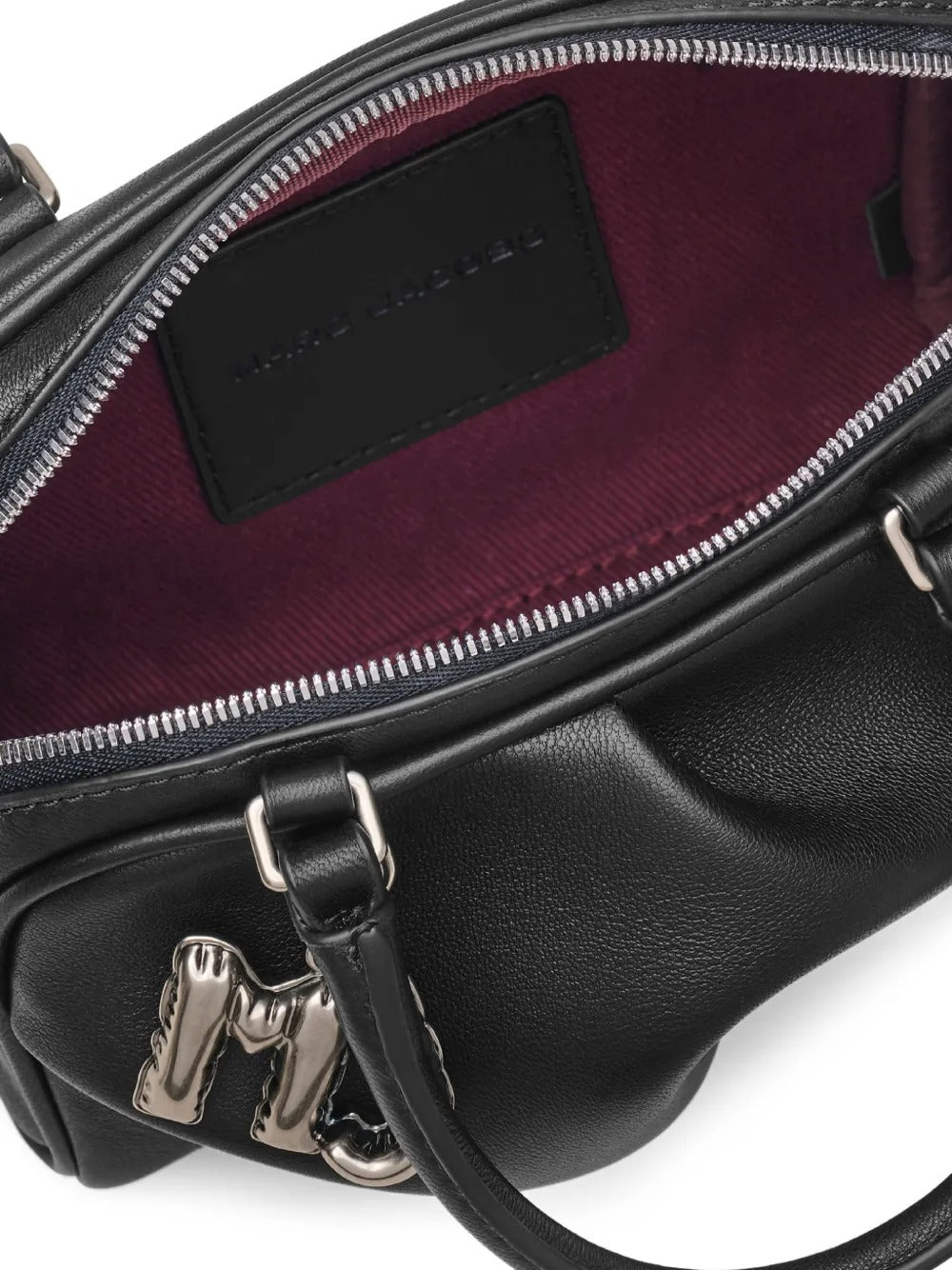 Close up of black bags, showing texture of the lamb leather fabric