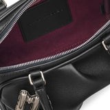 Close up of black bags, showing texture of the lamb leather fabric