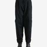 Black pants worn by a person, showing the pants' fit