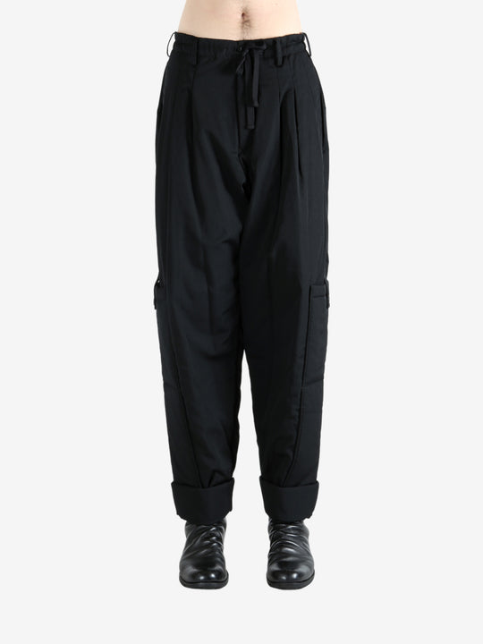 Black pants worn by a person, showing the pants' fit