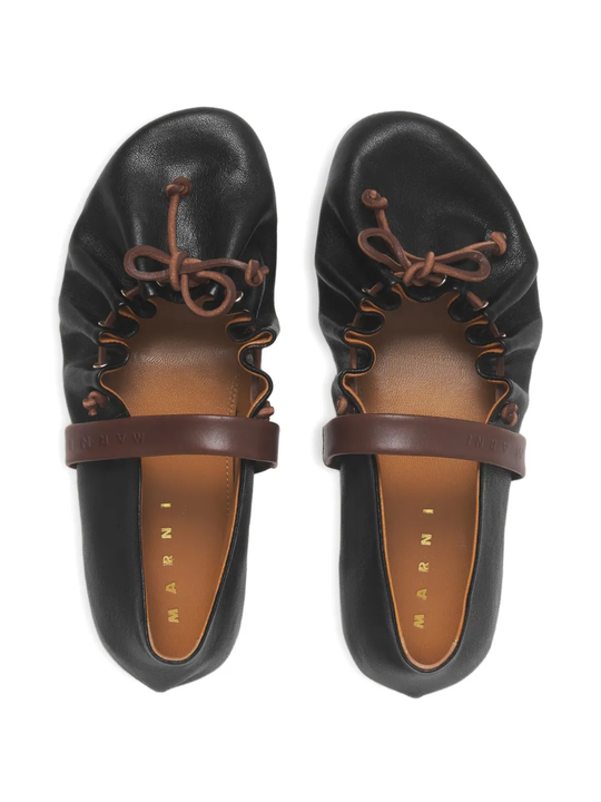 Close up of black flats, showing texture of the Bovine Leather fabric