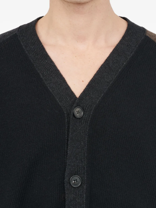 Close up of the black cardigan, showing texture of the wool and polyamide fabric