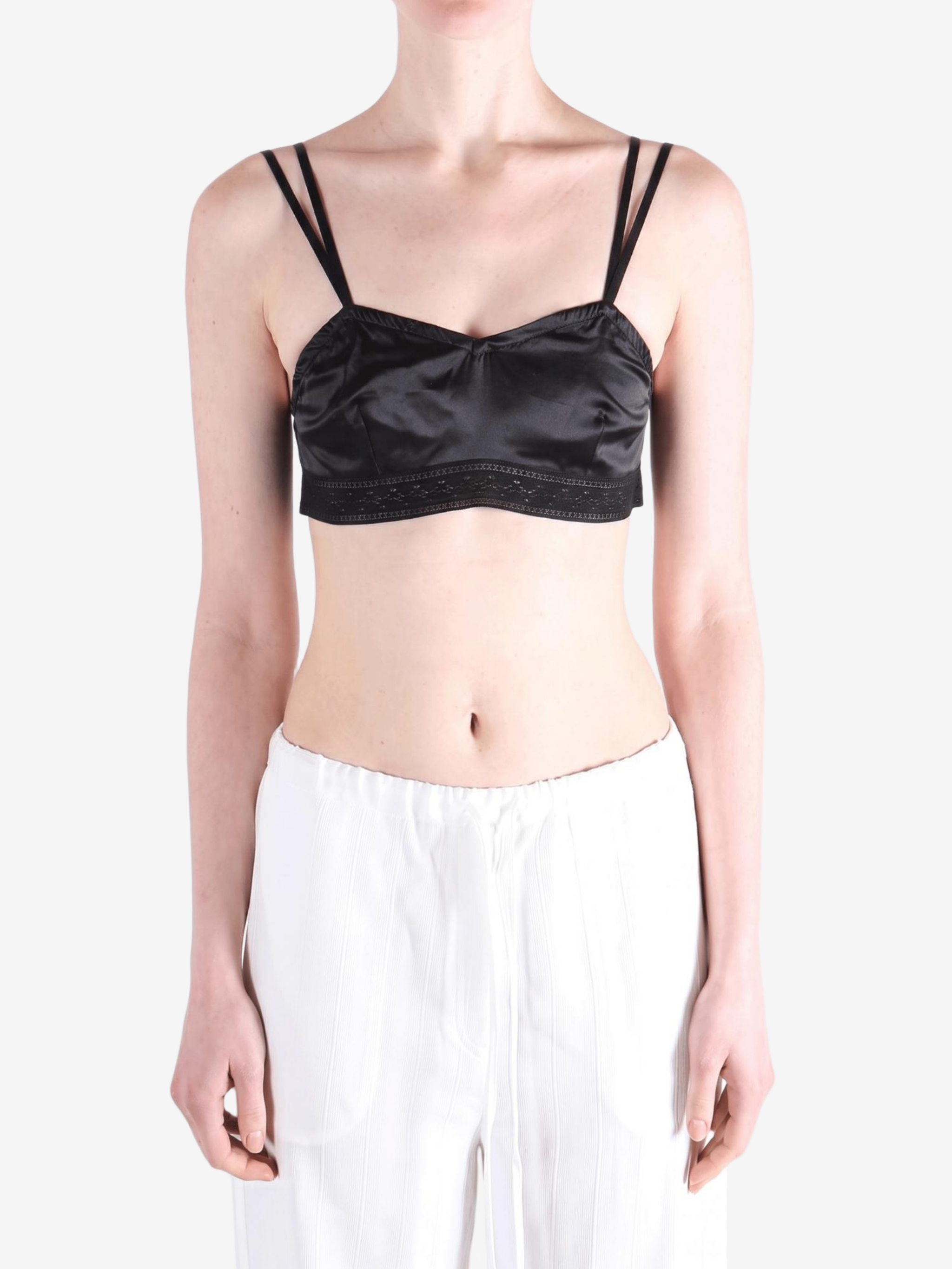 Black top worn by a person, showing the top fit