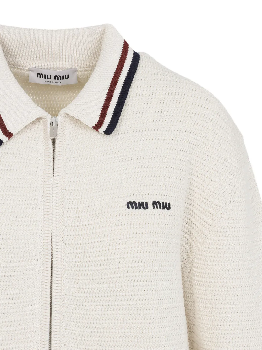 Close up of the White knitwear, showing texture of the cotton fabric