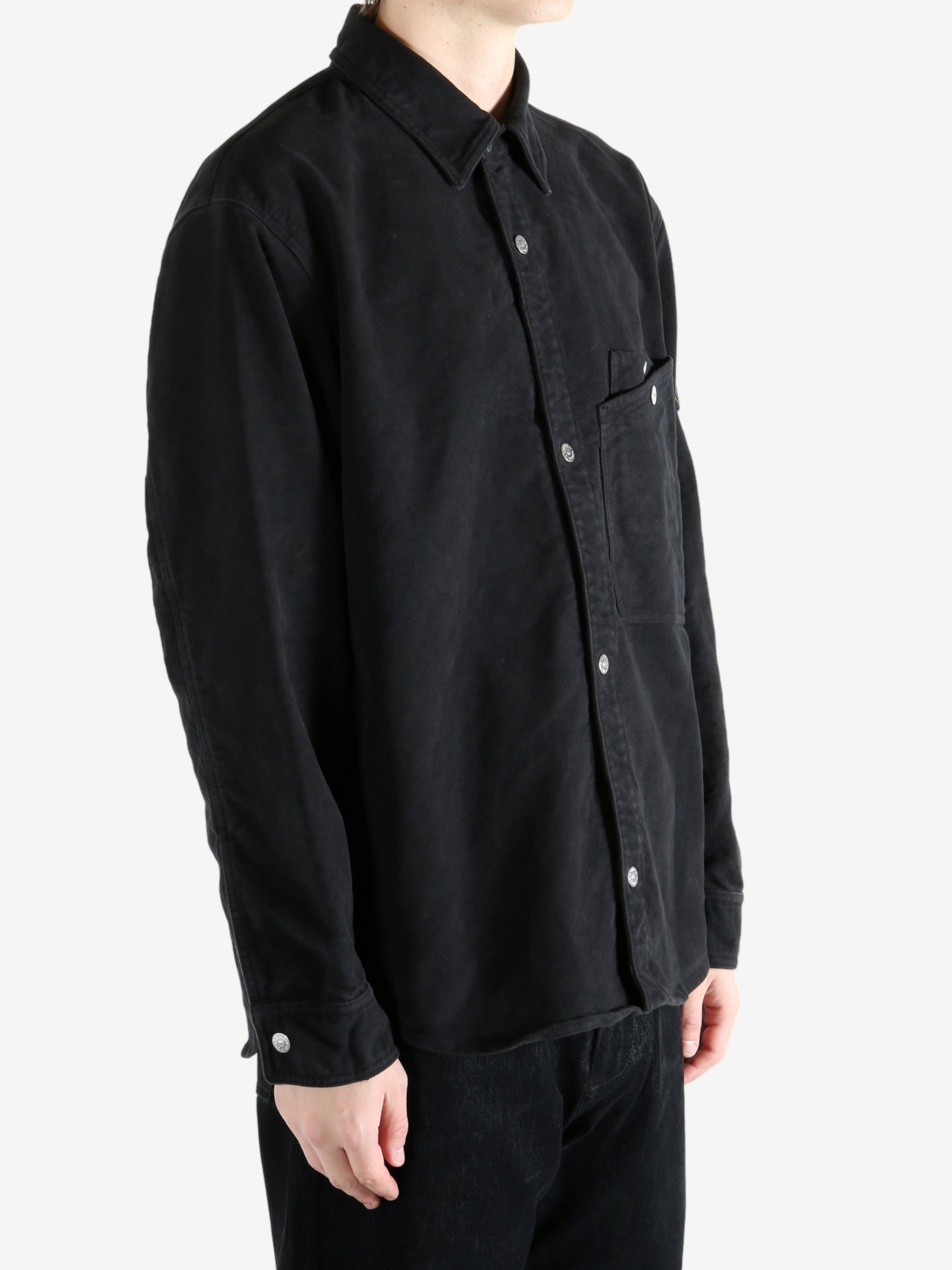 Black shirt worn by a person, showing the shirt's fit