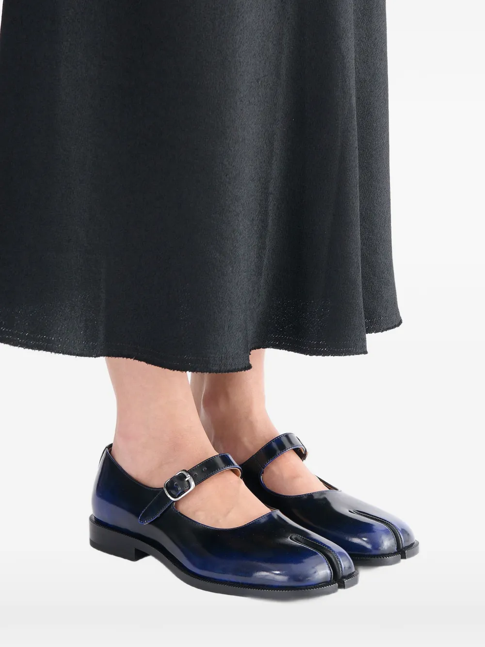 Black derbys worn by a person, showing the black derbys' fit