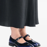 Black derbys worn by a person, showing the black derbys' fit