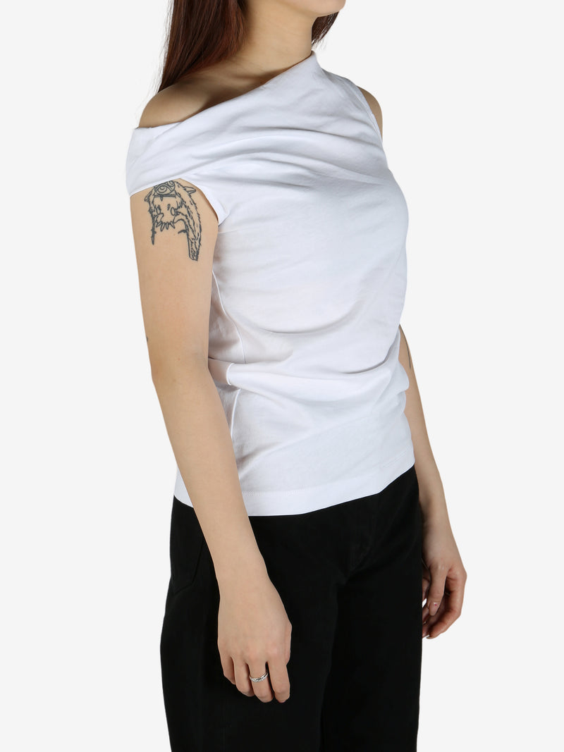 White top worn by a person, showing the top's fit