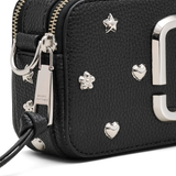 Close up of black bags, showing texture of the leather fabric