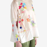 Tan top worn by a person, showing the top's fit