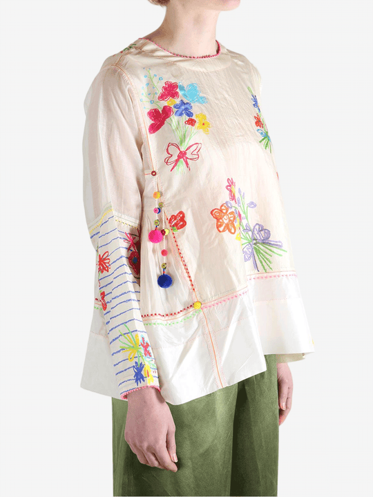 Tan top worn by a person, showing the top's fit