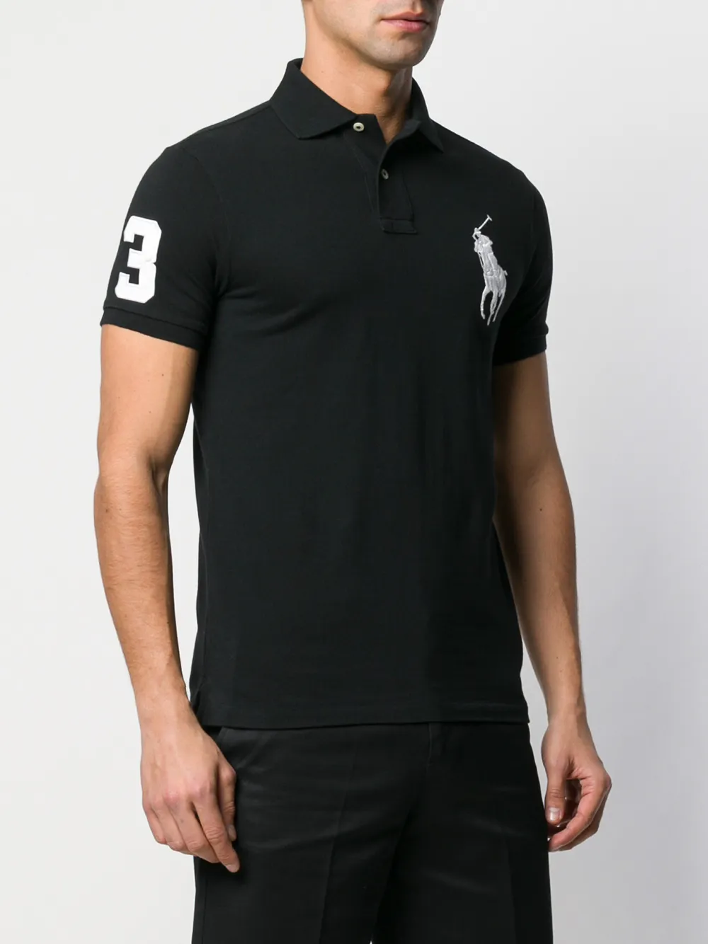 Black shirts worn by a person, showing the shirts fit
