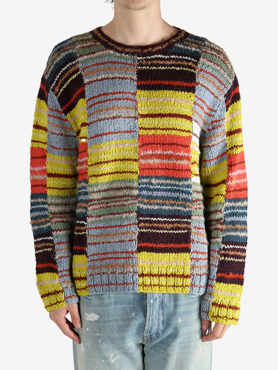 Yellow sweater worn by a person, showing the sweater’s fit