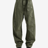 Green pants worn by a person, showing the pants fit