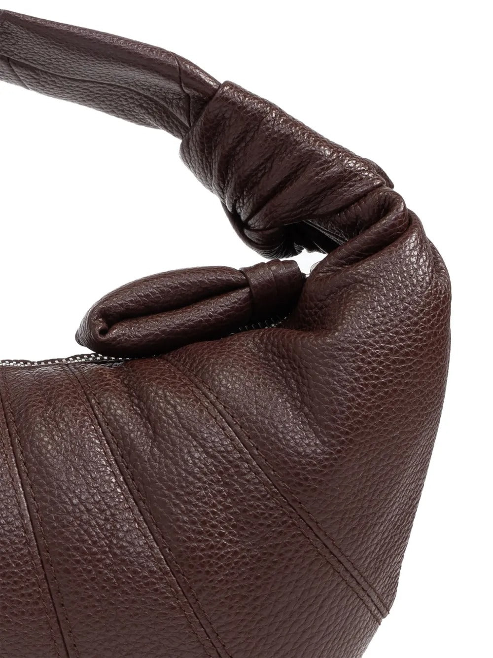 Close up of the brown bag, showing texture of the leather fabric