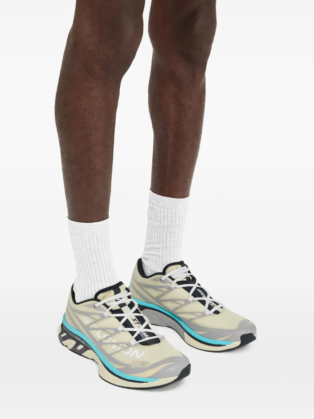 Tan sneakers worn by a person, showing the sneakers's fit