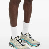 Tan sneakers worn by a person, showing the sneakers's fit