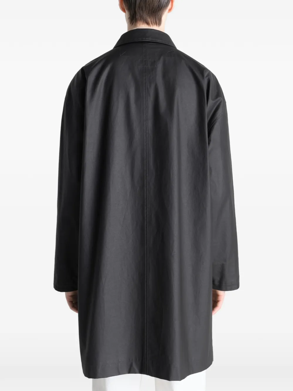 Black jacket worn by a person, showing the jacket's fit