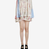 Tan shirt worn by a person, showing the shirt’s fit