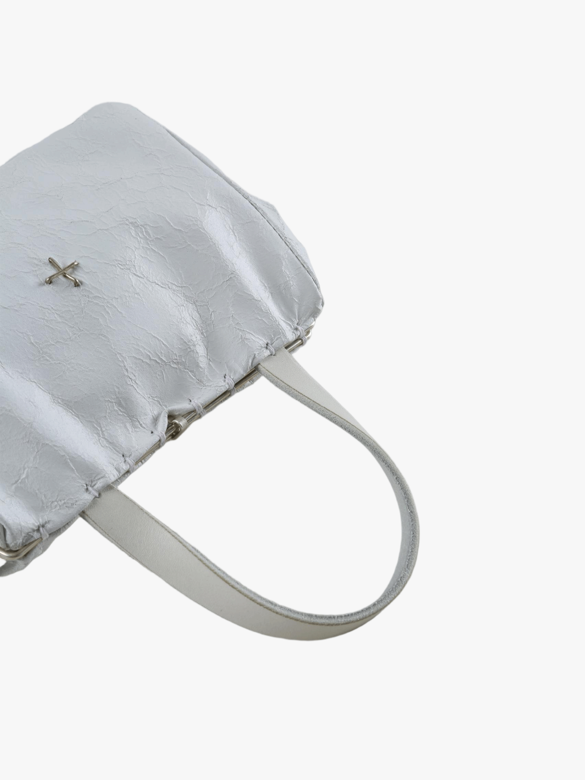 Close-up of white bag, showing texture of the fabric