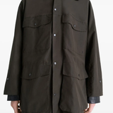 Brown coats worn by a person, showing the coats fit