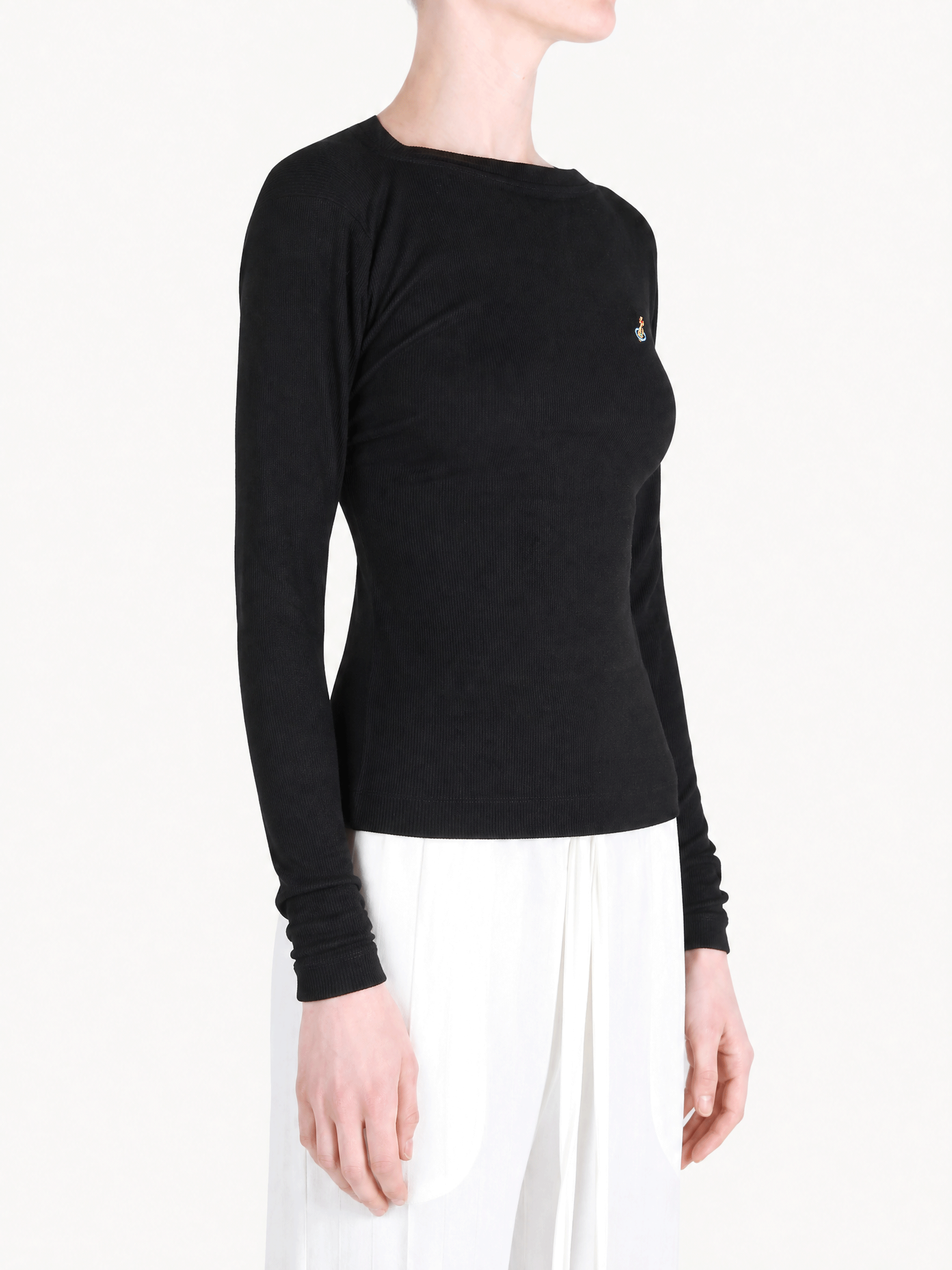 Black top worn by a person, showing the top fit