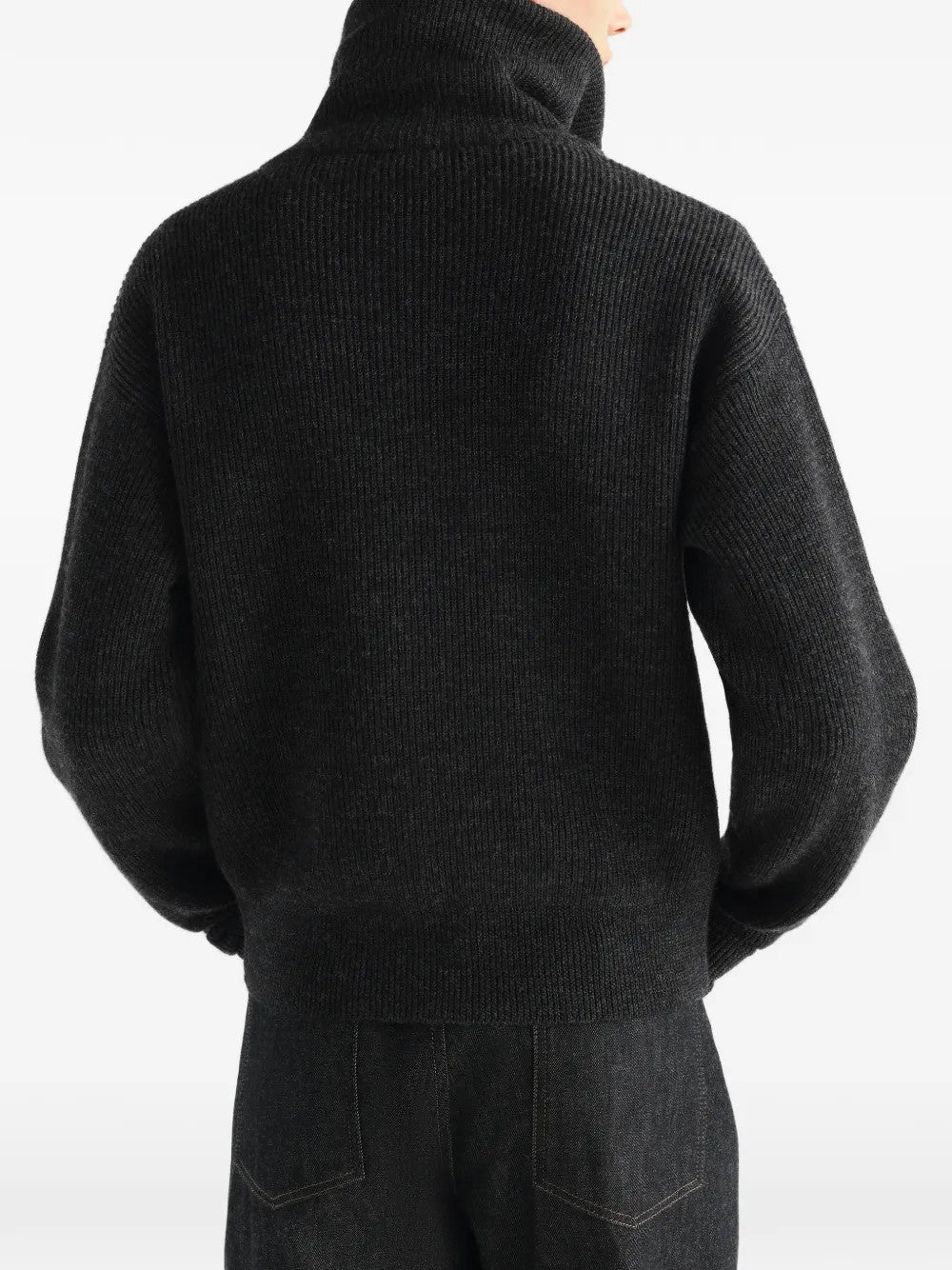 Black knitwear worn by a person, showing the knitwear fit