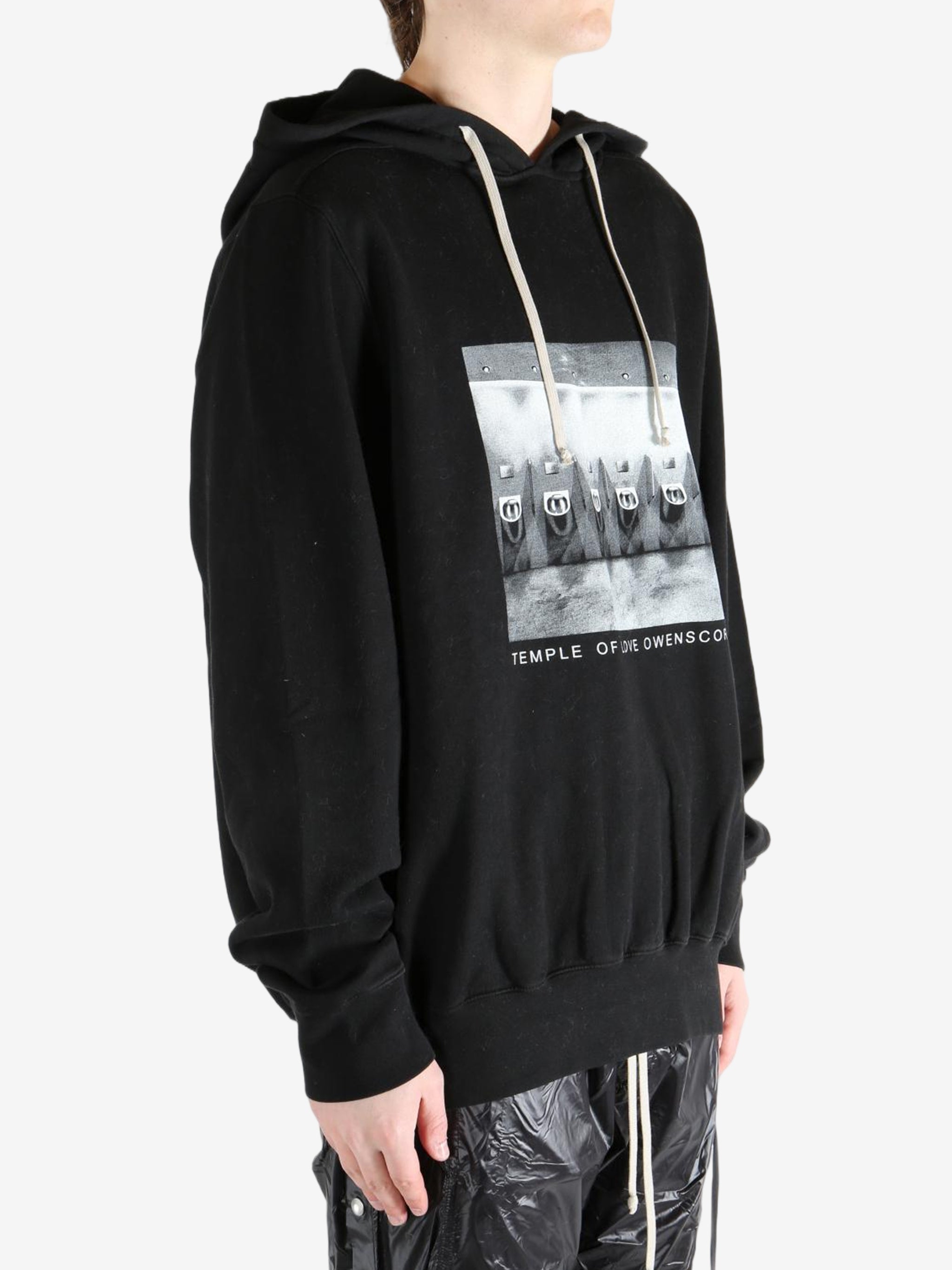 Black hoodie worn by a person, showing the hoodie's fit