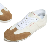 Close up of the white sneakers, showing texture of the polyamide and suede fabric